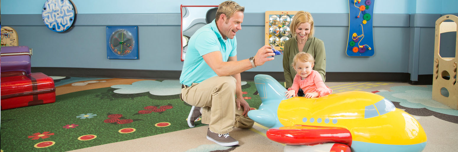 Parents playing with child at playground