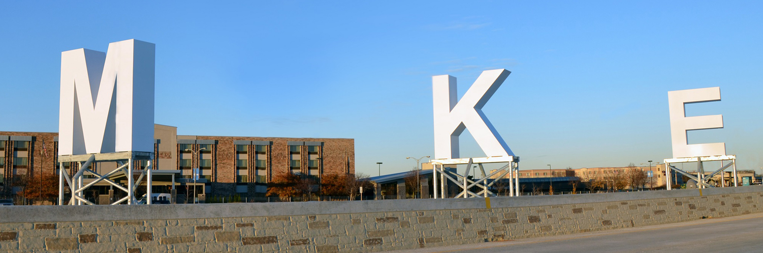 Large Letters M K E with building in background